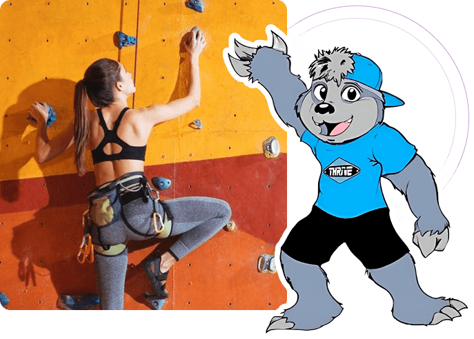 A woman in black top and blue shirt climbing up wall.